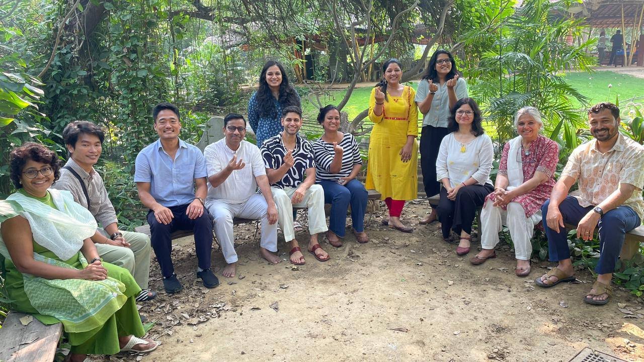 Members of the NWG-CCA seated together in a garden