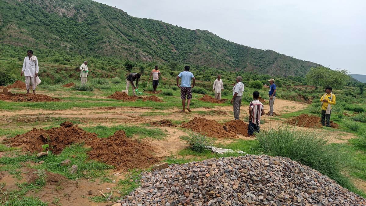 Villagers preparing plantation pits on a hillside